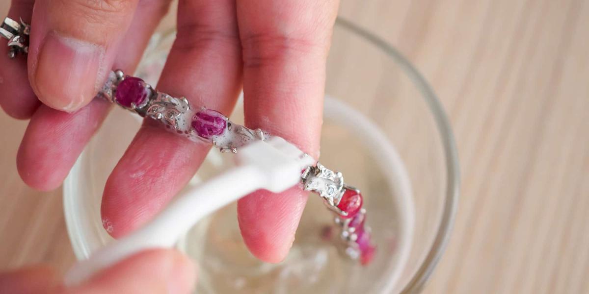 Picture of person cleaning a piece of jewellery
