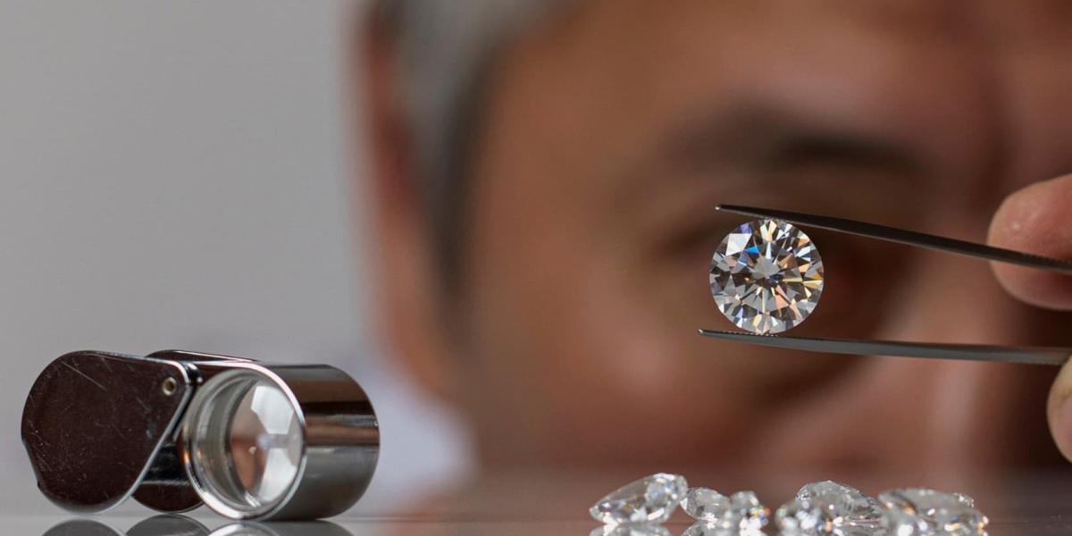 Close up of diamond dealer evaluating lab-grown diamond