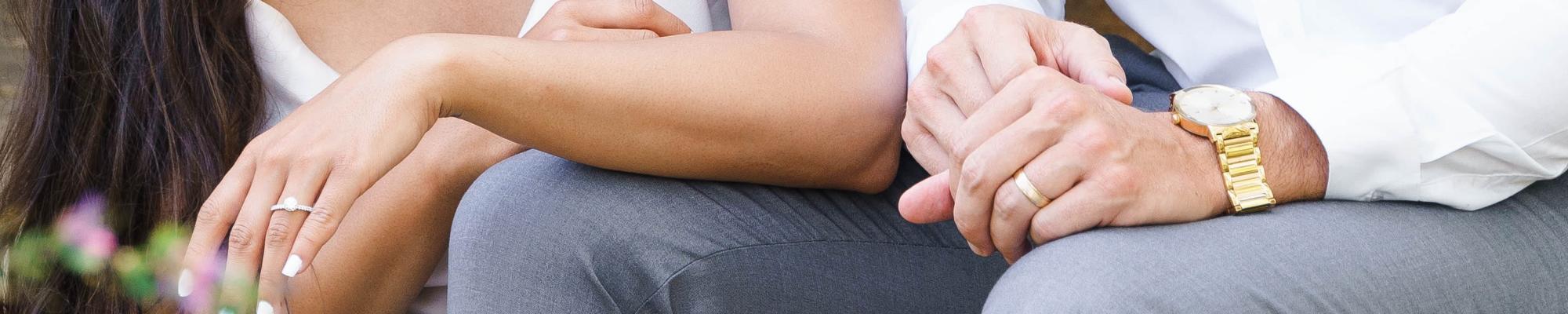 man with hand on woman's arm