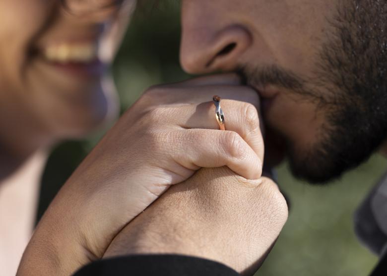 groom kissing bride's hand 