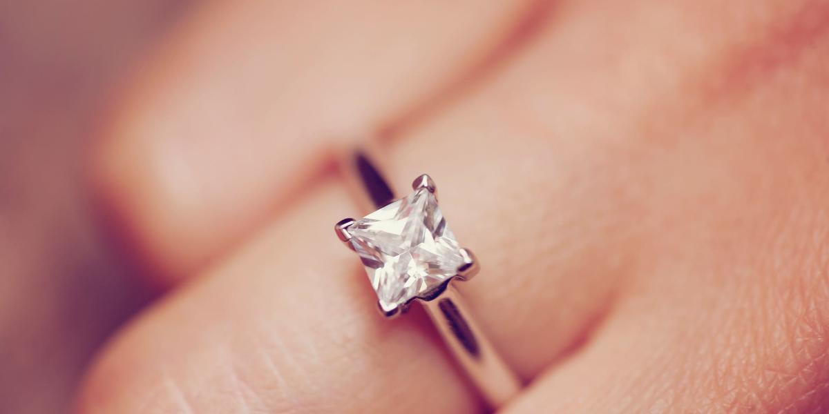 Picture of an engagement ring with a princess cut diamond